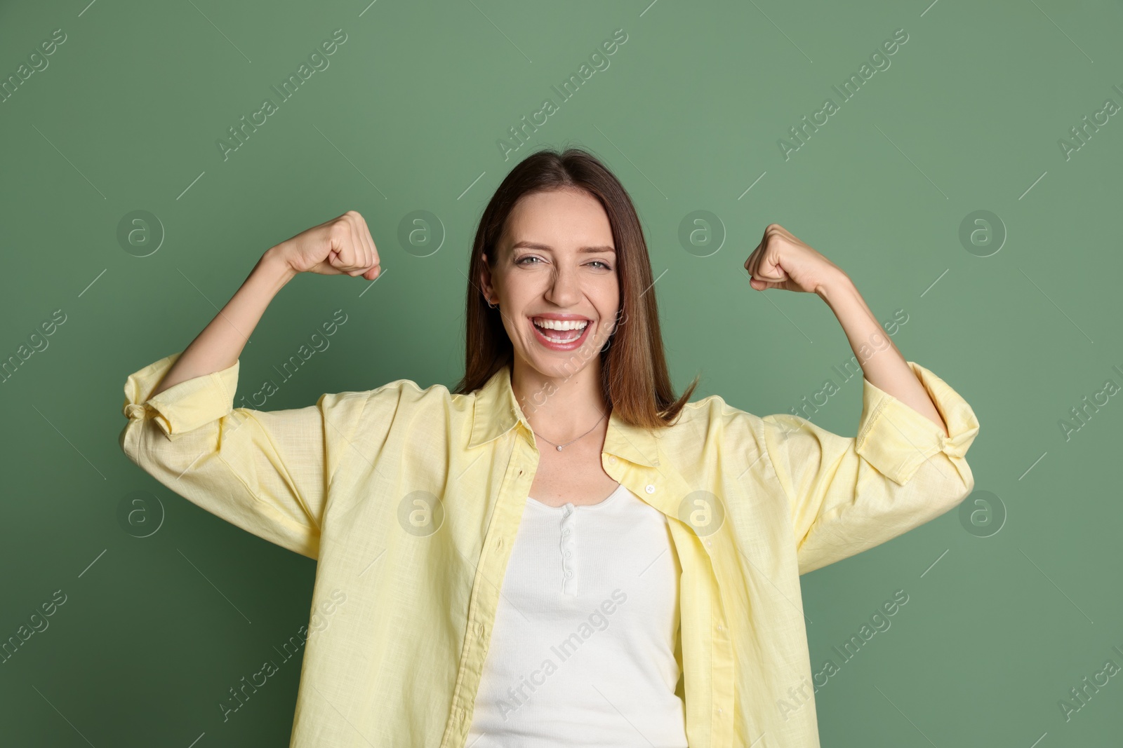 Photo of Portrait of happy winner on green background