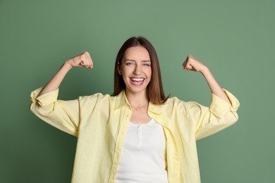 Photo of Portrait of happy winner on green background