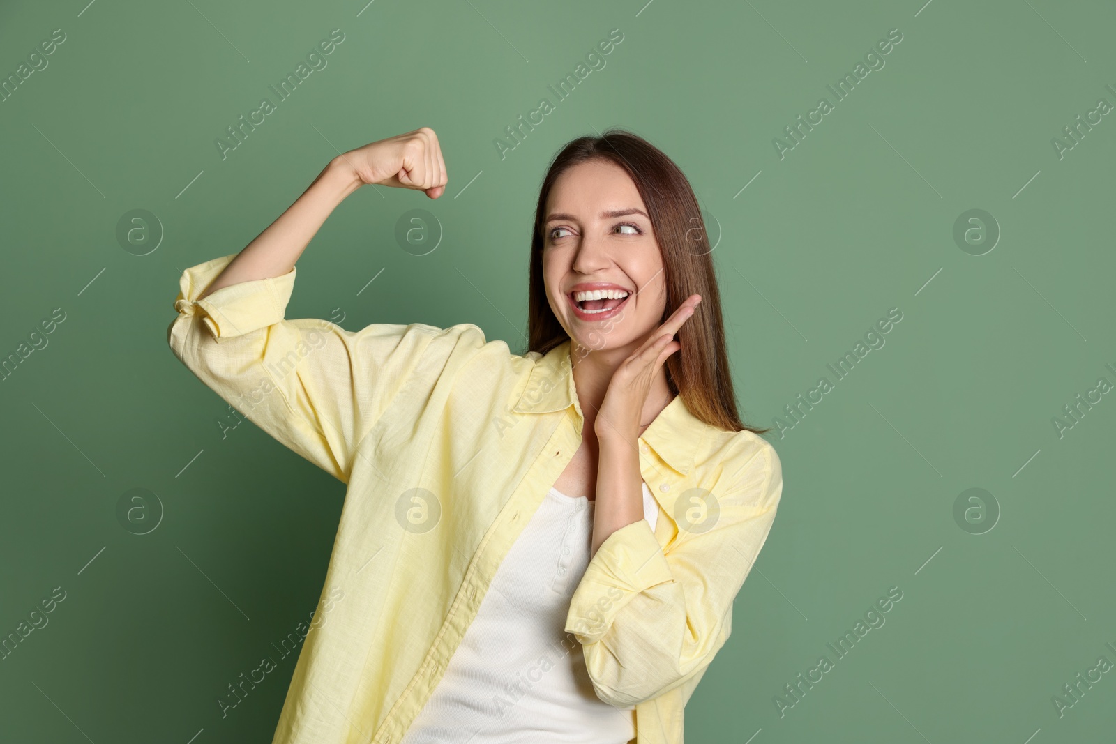 Photo of Portrait of happy winner on green background