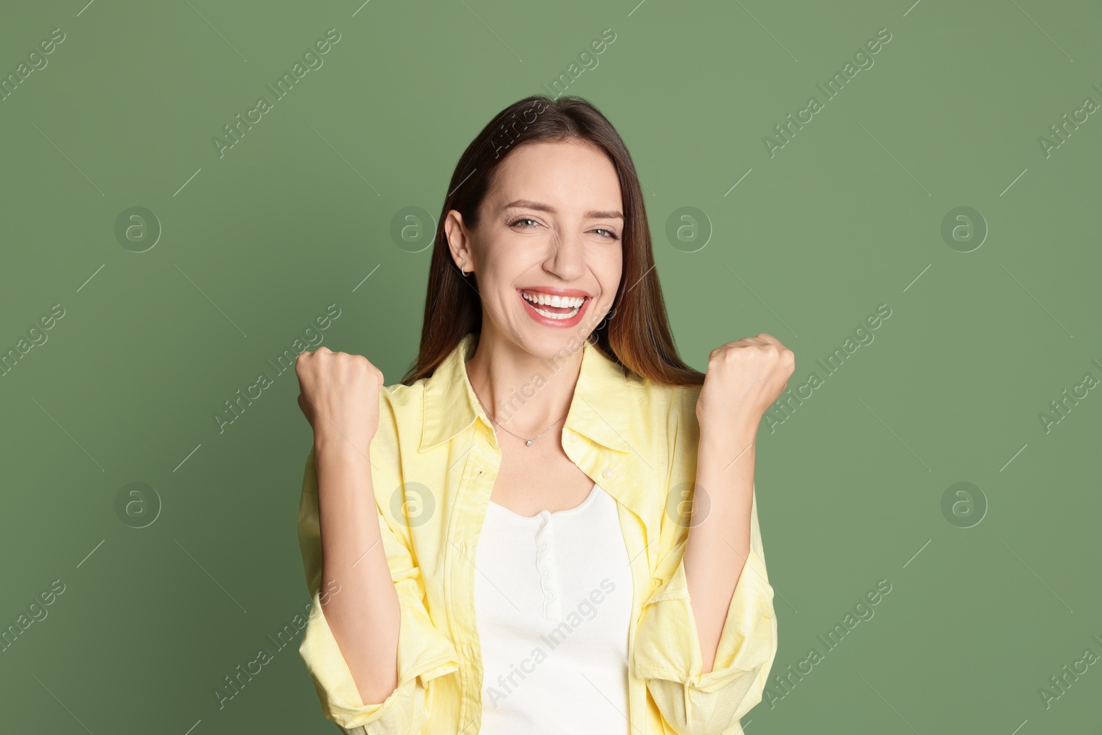 Photo of Portrait of happy winner on green background