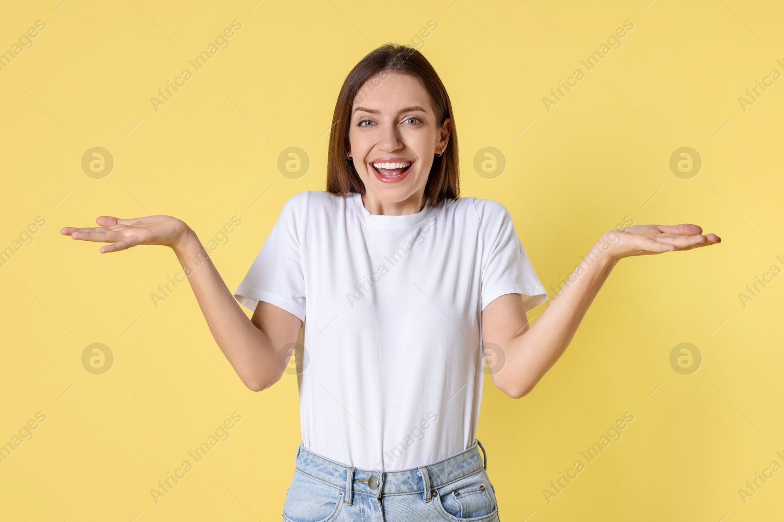 Photo of Portrait of happy winner on yellow background