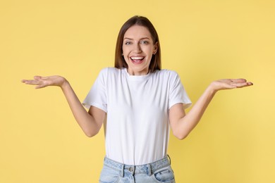 Portrait of happy winner on yellow background