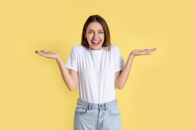 Photo of Portrait of happy winner on yellow background