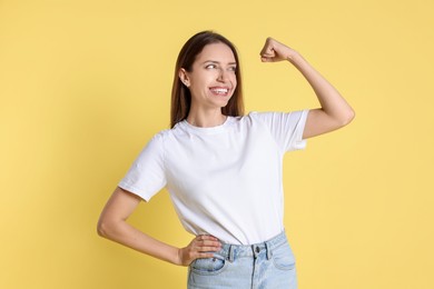 Photo of Portrait of happy winner on yellow background