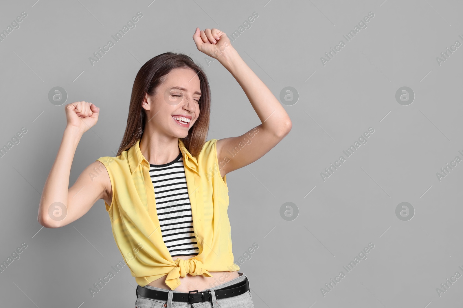 Photo of Portrait of happy winner on gray background