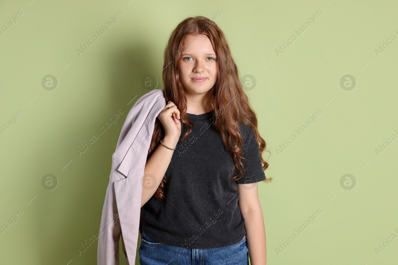 Photo of Cute teenage girl with jacket on green background