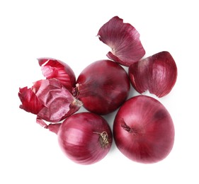 Photo of Fresh onions with peels isolated on white, top view