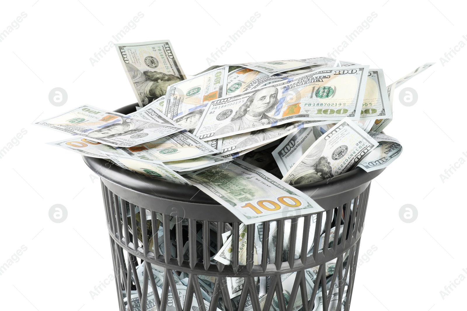 Photo of Many dollar banknotes in trash bin isolated on white