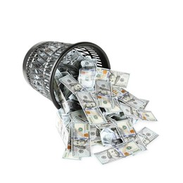 Photo of Many dollar banknotes and overturned trash bin isolated on white