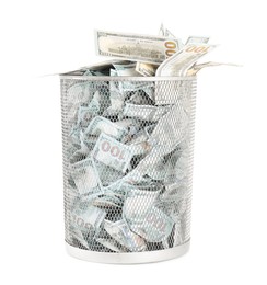 Photo of Many dollar banknotes in trash bin isolated on white