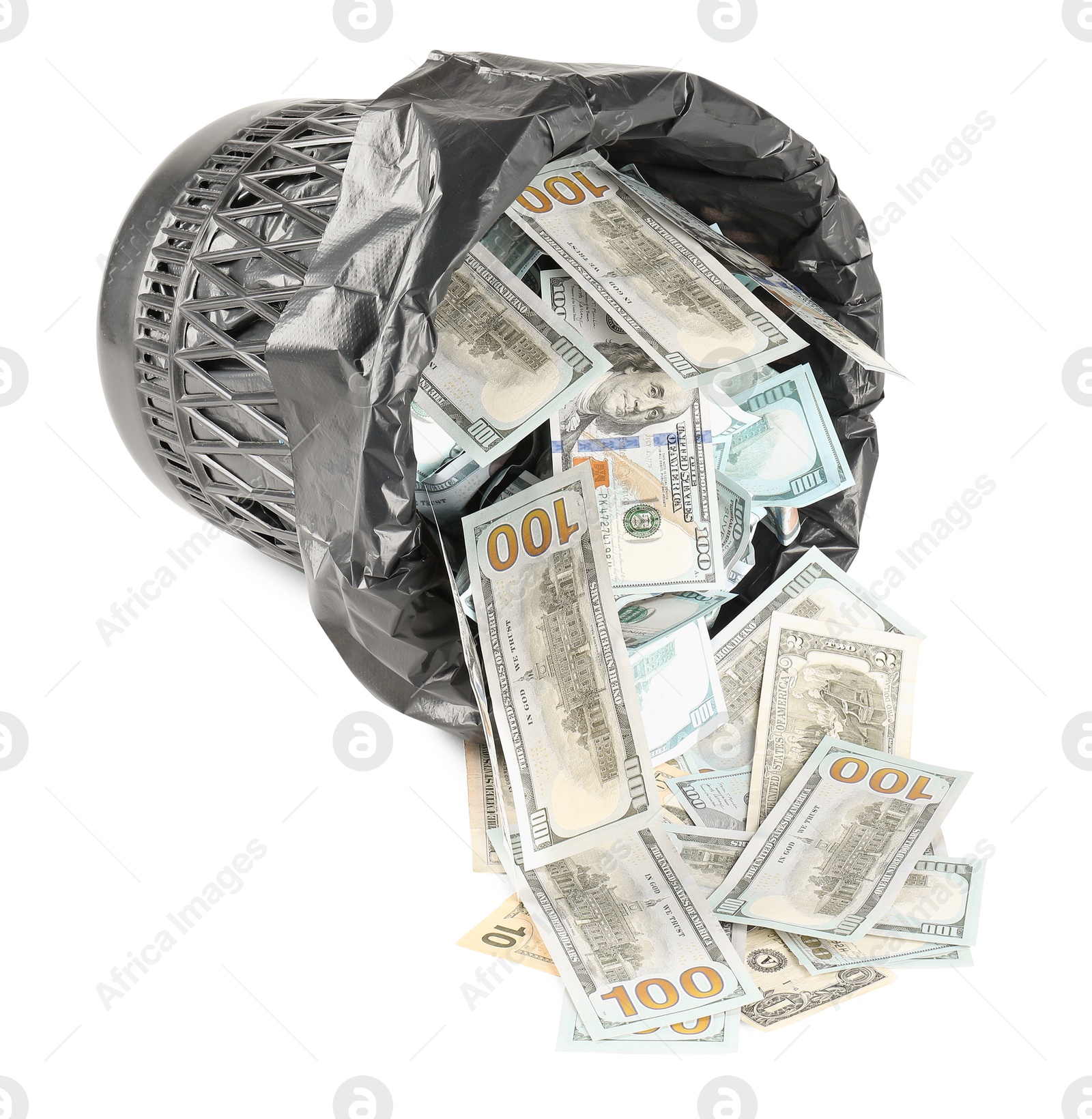 Photo of Many dollar banknotes and overturned trash bin isolated on white