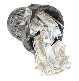 Photo of Many dollar banknotes and overturned trash bin isolated on white