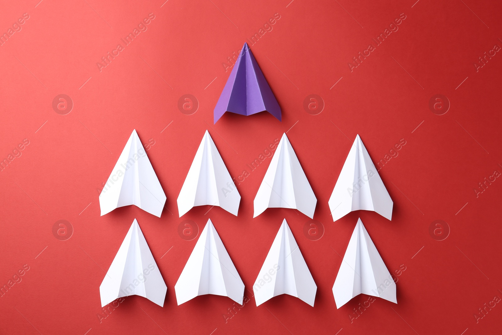 Photo of Paper planes on red background, top view