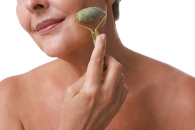 Photo of Woman doing facial massage with roller on white background, closeup