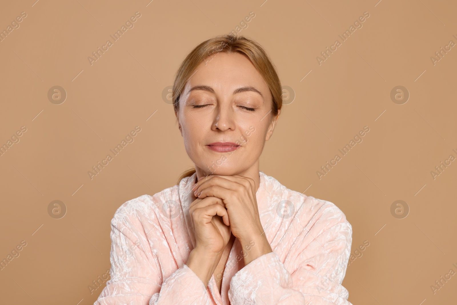 Photo of Portrait of beautiful woman with healthy skin on beige background