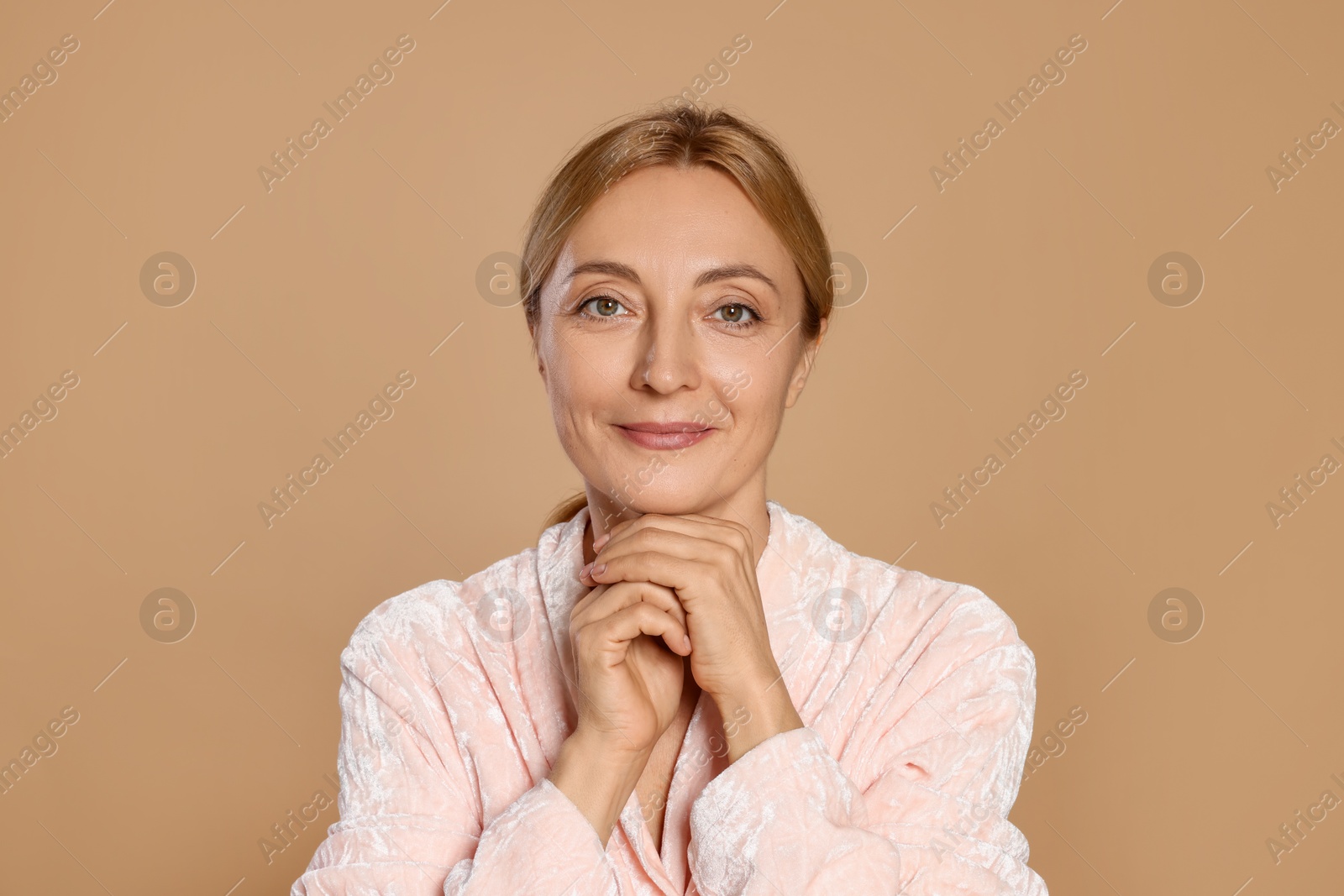 Photo of Portrait of beautiful woman with healthy skin on beige background