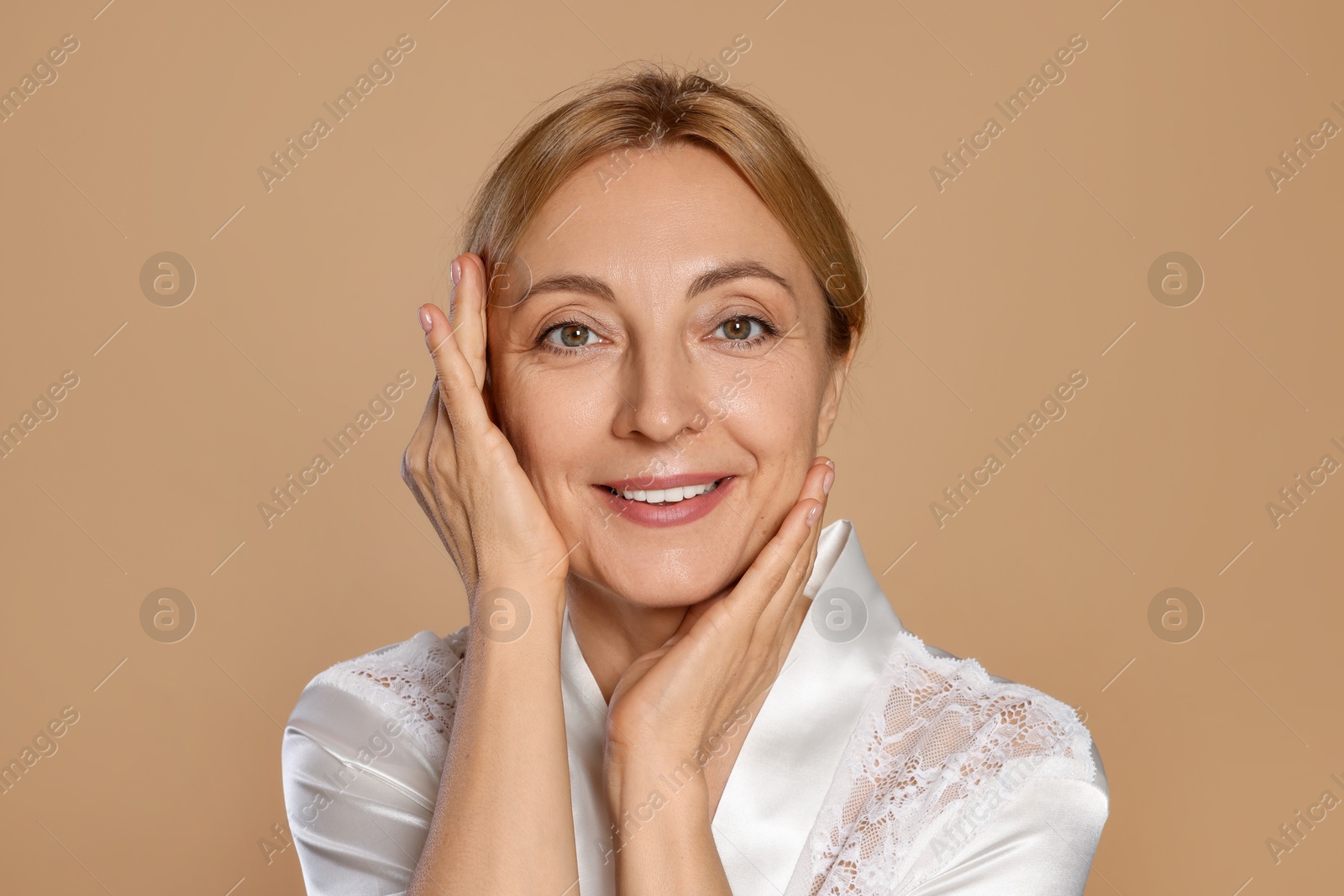 Photo of Portrait of smiling woman with healthy skin on beige background