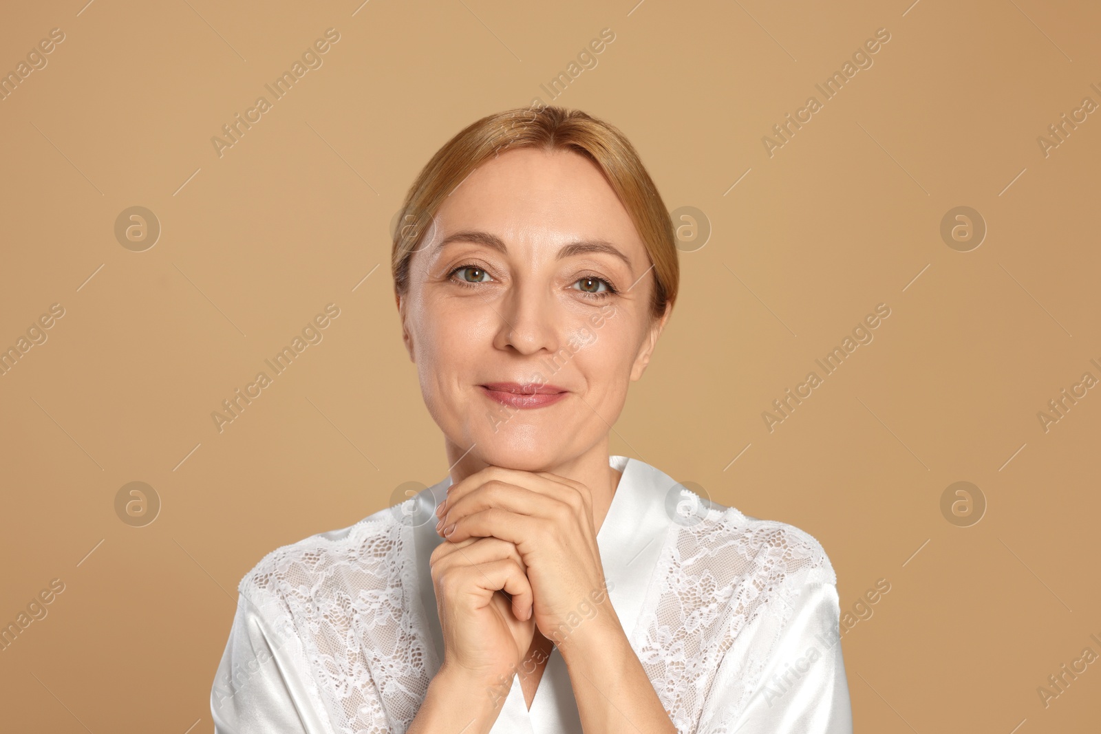 Photo of Portrait of beautiful woman with healthy skin on beige background