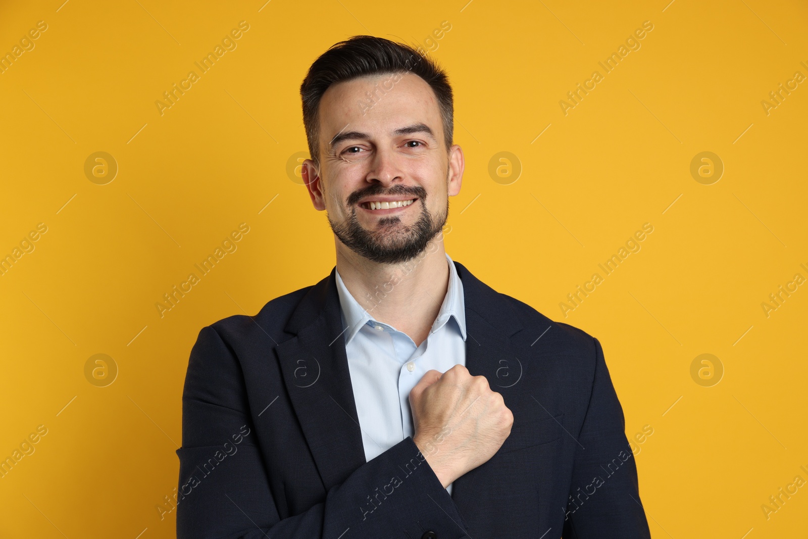 Photo of Man making promise on orange background. Oath gesture