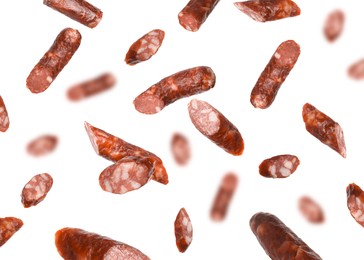 Image of Dry smoked sausage pieces in air on white background, collage