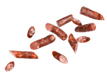 Image of Dry smoked sausage pieces in air on white background, collage