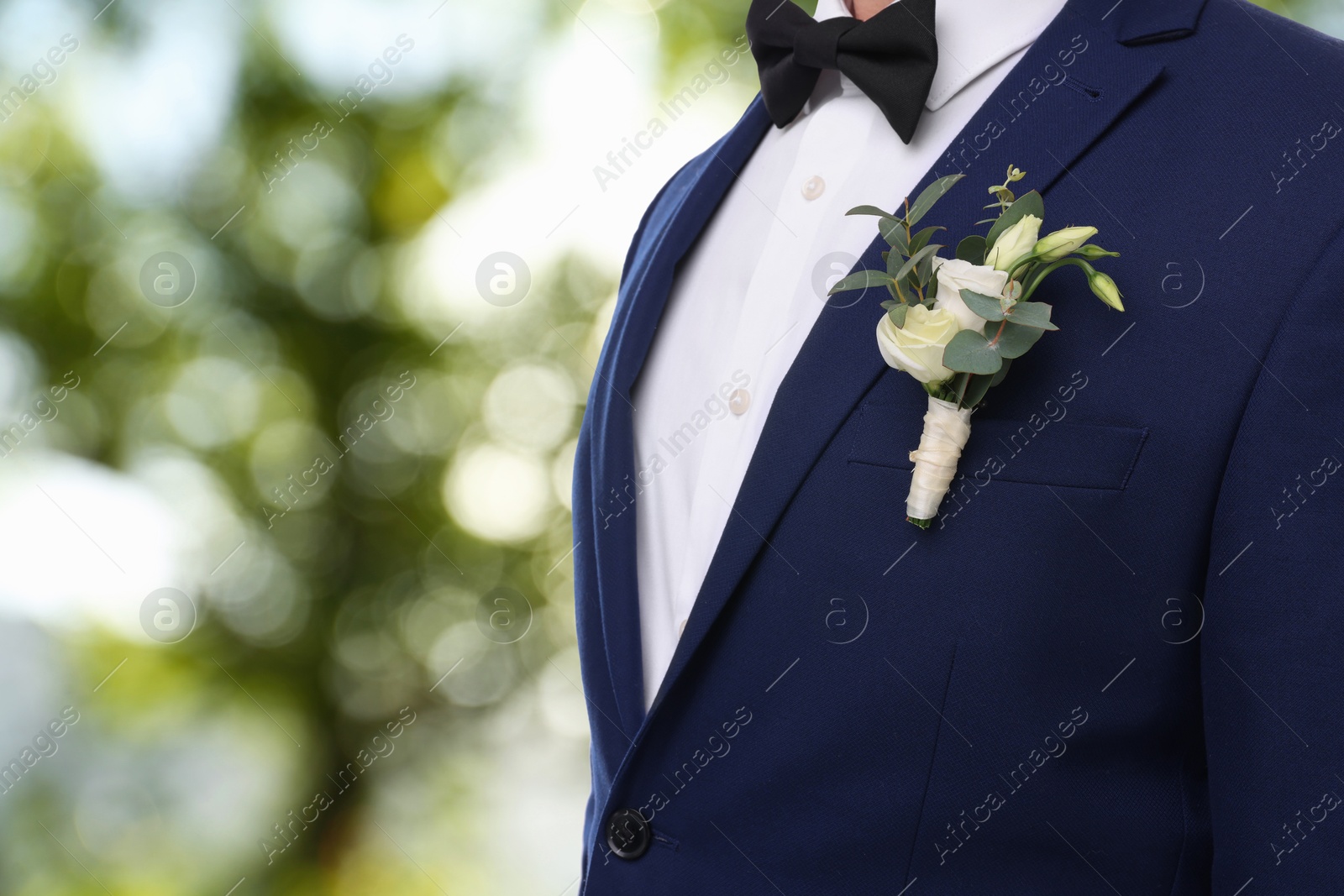 Image of Groom with boutonniere outdoors, closeup. Wedding accessory