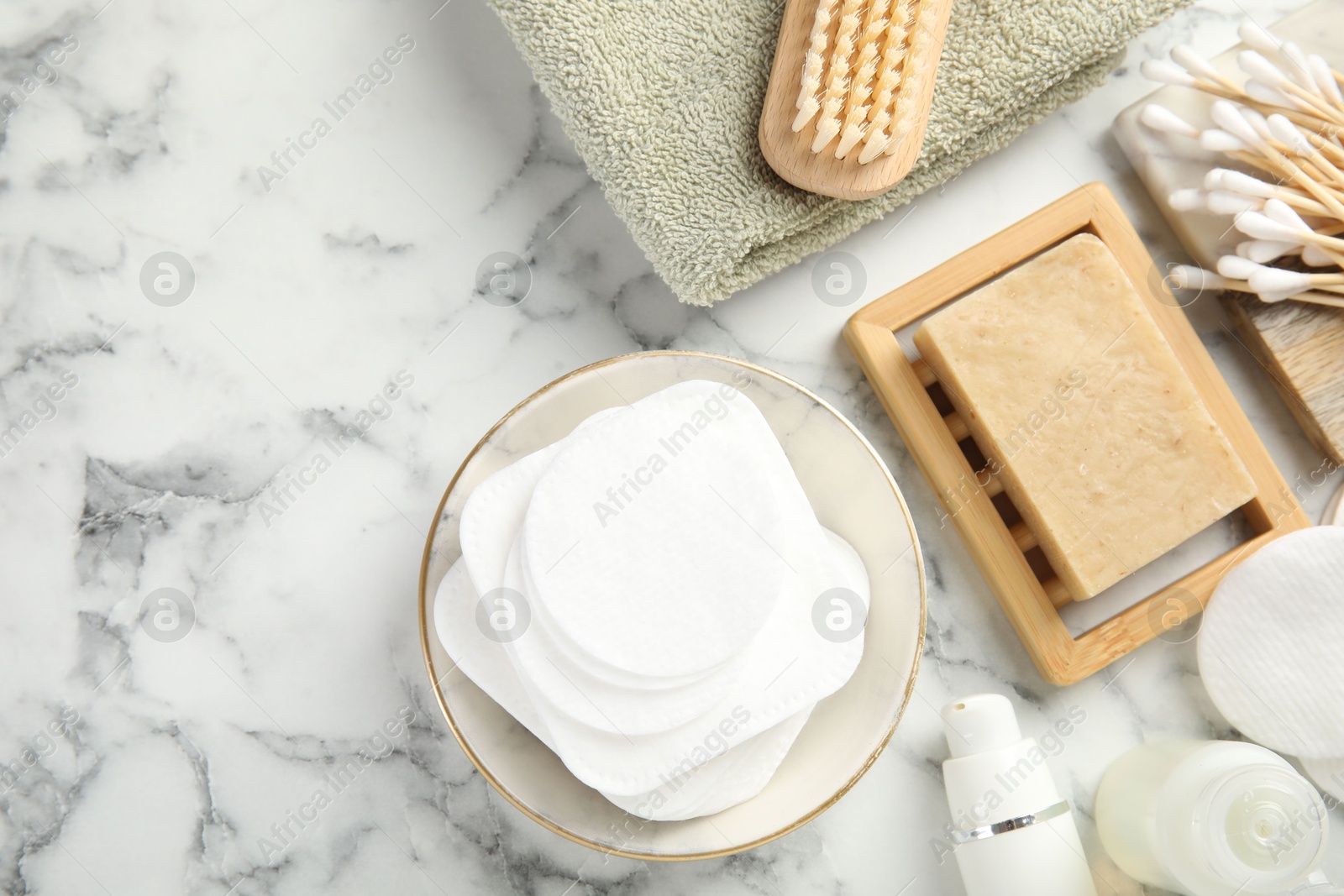 Photo of Flat lay composition with cotton pads on light marble table, space for text