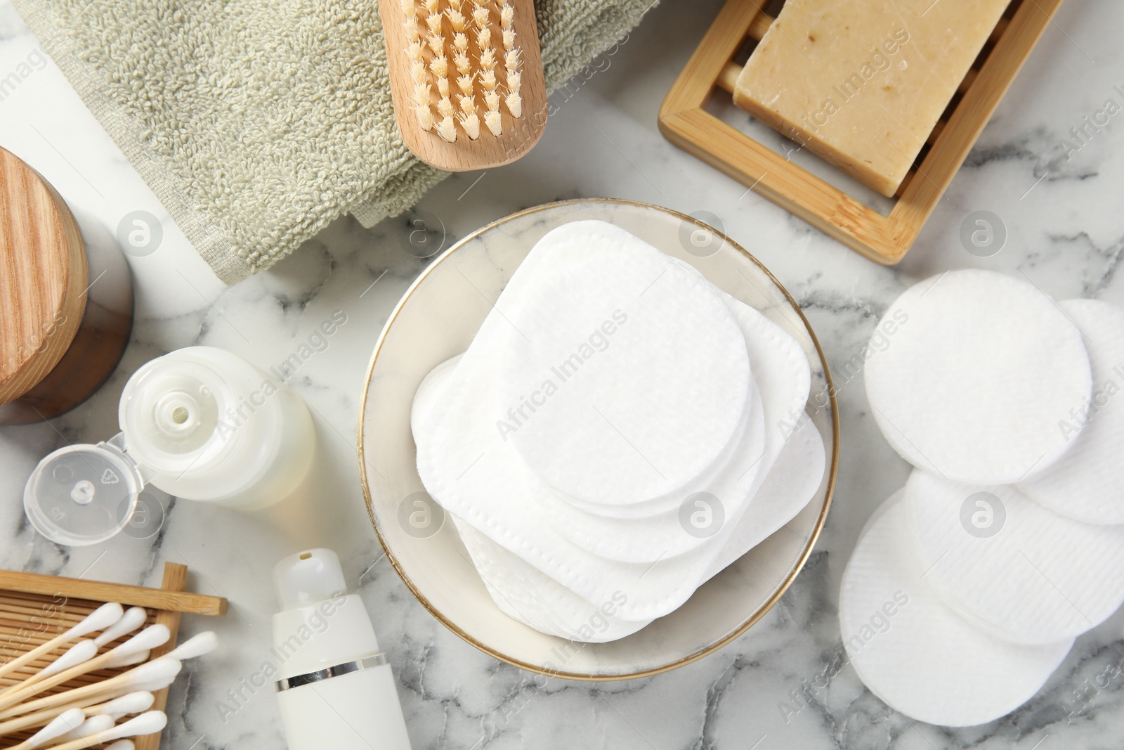 Photo of Flat lay composition with cotton pads on light marble table