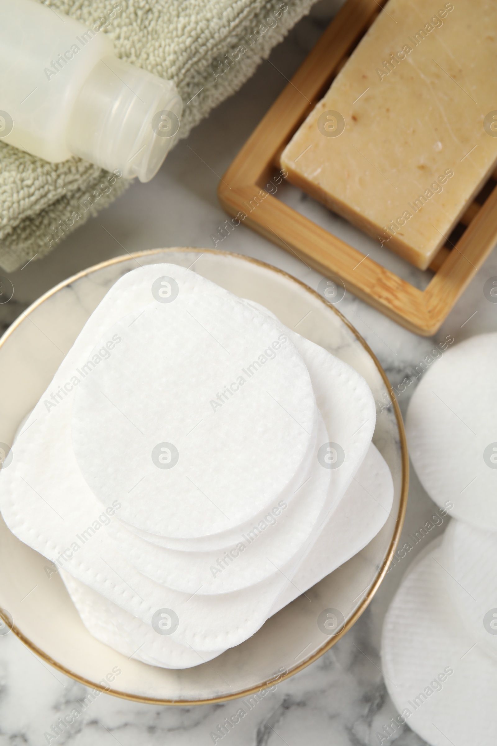 Photo of Flat lay composition with cotton pads on light marble table