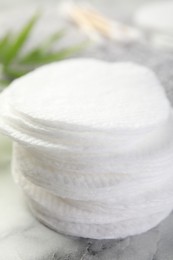 Photo of Cotton pads on light marble table, closeup