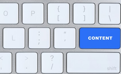 Image of Computer keyboard with word Content on blue button, closeup