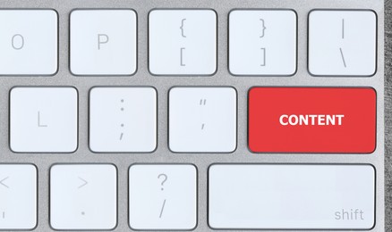 Image of Computer keyboard with word Content on red button, closeup