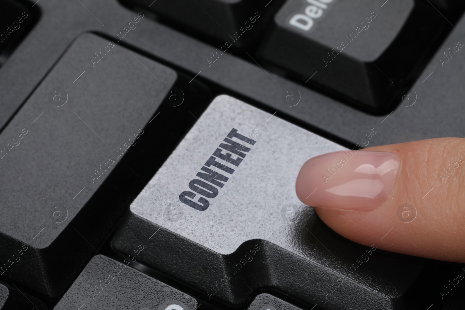 Image of Woman pushing button with word Content on computer keyboard, closeup