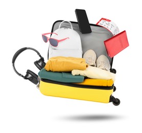 Image of Suitcase, clothes and other items in air on white background. Ready to travel