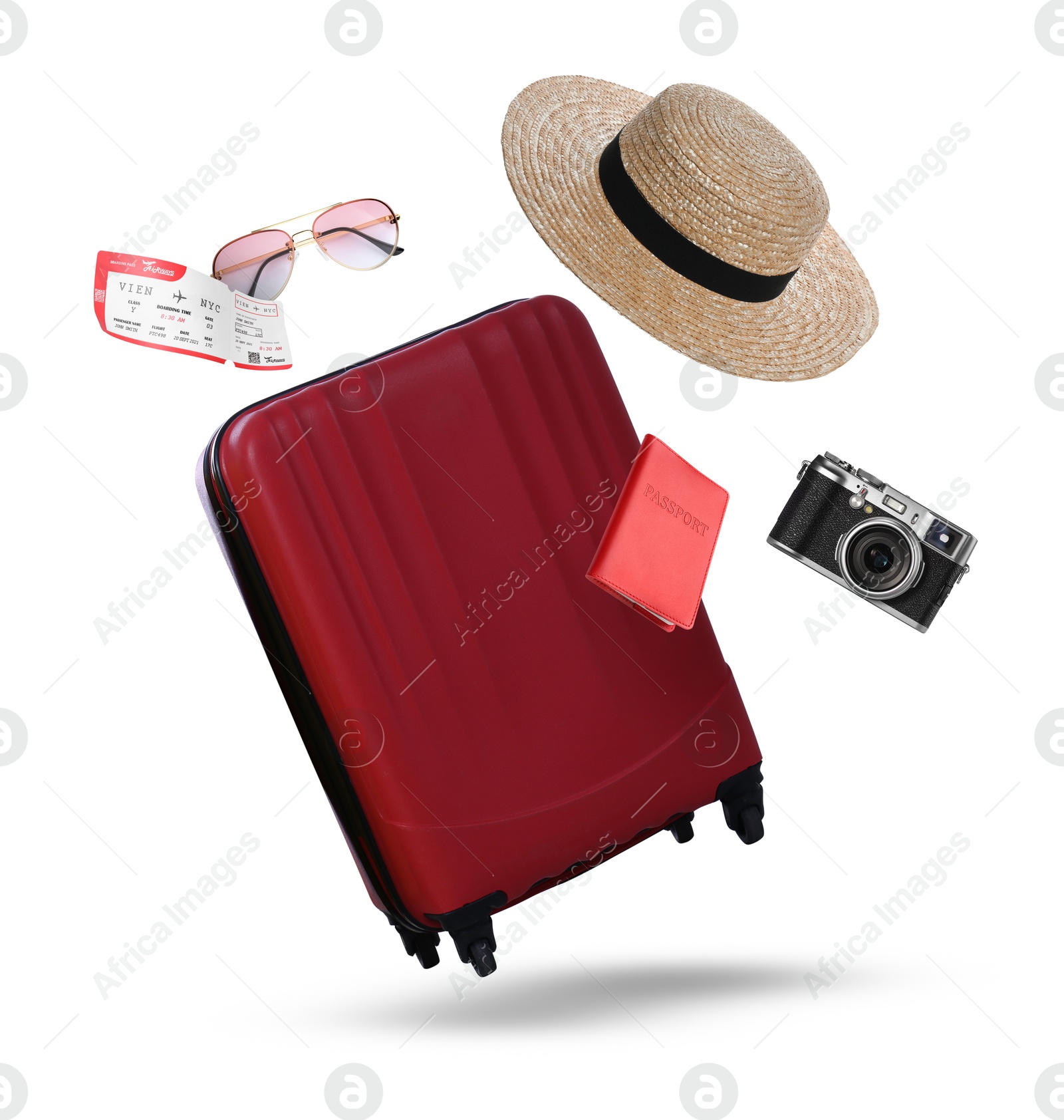 Image of Suitcase, passport, ticket, hat, sunglasses and camera in air on white background. Ready to travel