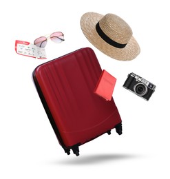 Image of Suitcase, passport, ticket, hat, sunglasses and camera in air on white background. Ready to travel