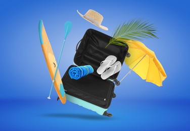 Image of Suitcase and beach items in air on blue background. Ready to travel