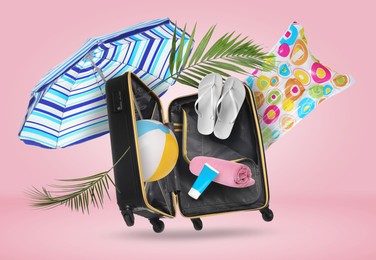 Image of Suitcase and beach items in air on pink background. Ready to travel