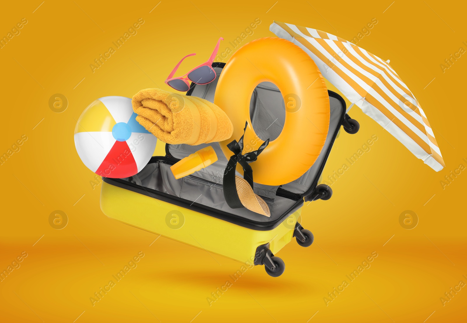 Image of Suitcase and beach items in air on orange background. Ready to travel