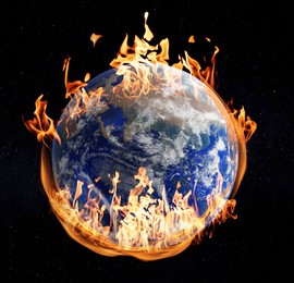 Image of Planet Earth on fire against black background. Conceptual image for global warming. Image elements furnished by NASA