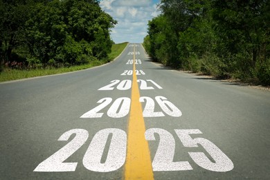 Asphalt road with 2025, 2026 and so on signs. Concept of new year, fresh beginning