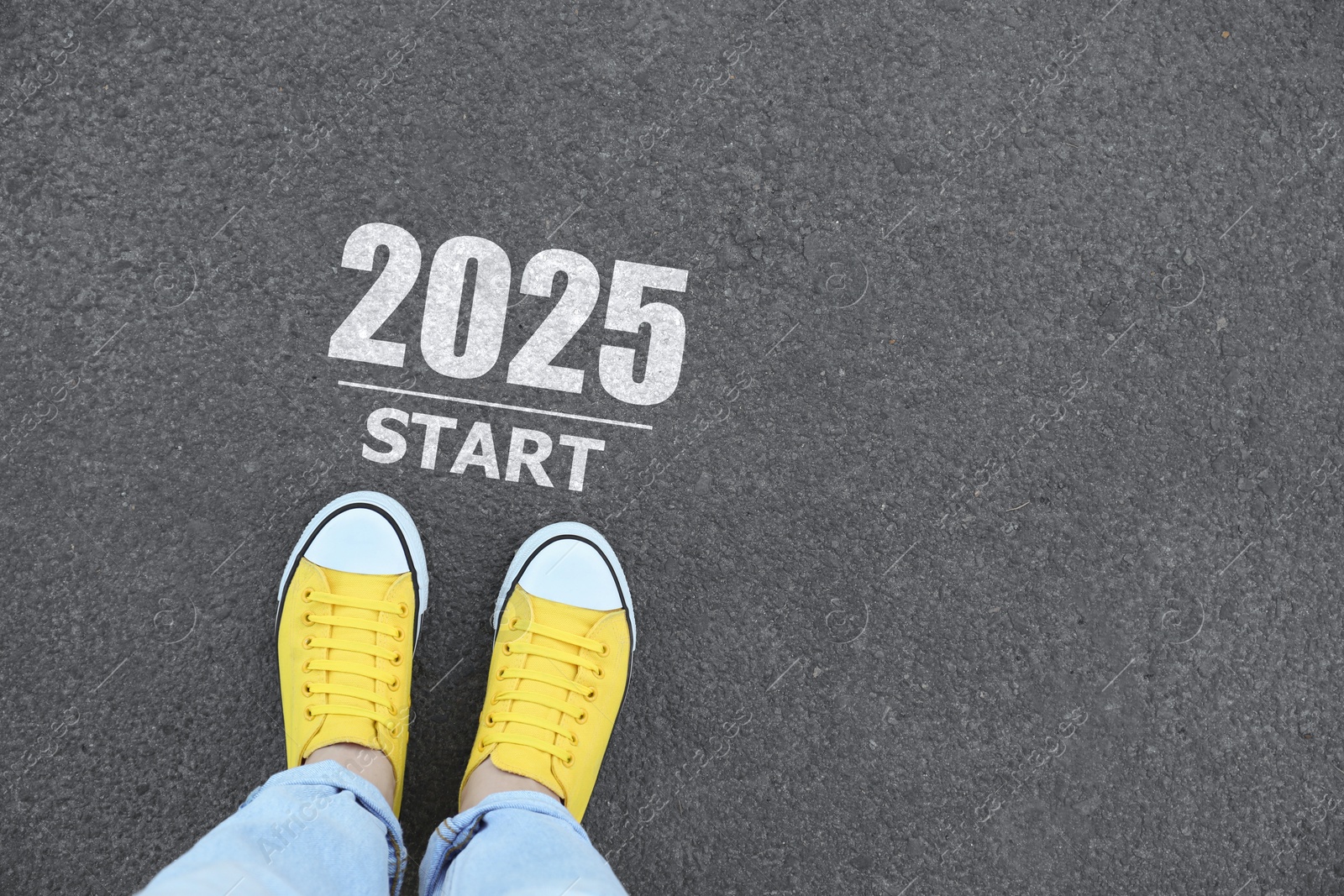 Image of Woman standing near sign 2025 Start on asphalt, top view. Concept of new year, fresh beginning