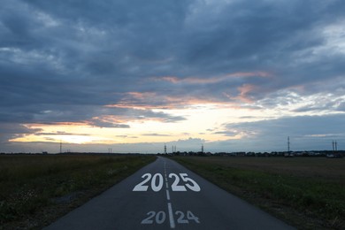 Image of Asphalt road with 2024 and 2025 signs. Concept of new year, fresh beginning