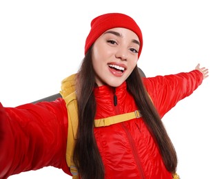 Smiling young woman with backpack taking selfie on white background. Active tourism