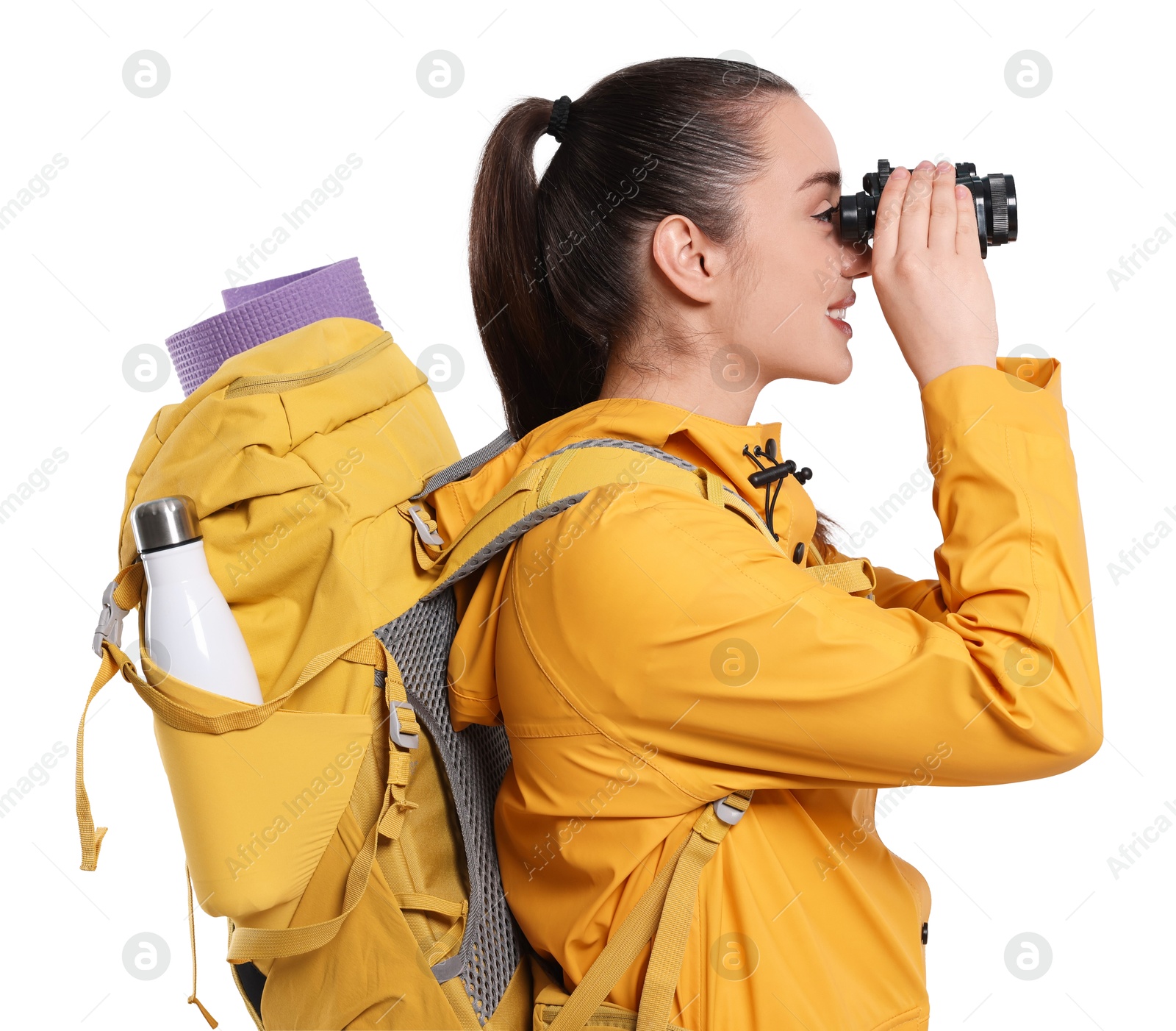 Photo of Young woman with backpack looking through binoculars on white background. Active tourism