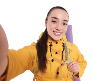 Smiling young woman with backpack taking selfie on white background. Active tourism