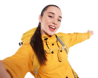 Smiling young woman with backpack taking selfie on white background. Active tourism