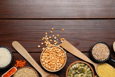 Photo of Different types of legumes, seeds and cereals on wooden table, flat lay. Space for text