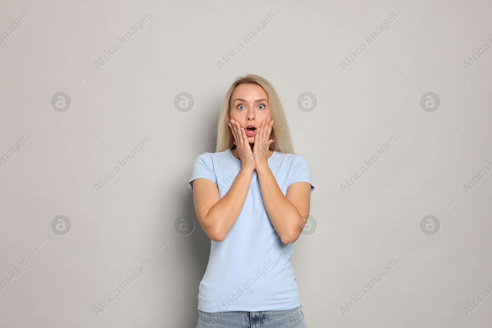 Photo of Portrait of scared woman on gray background