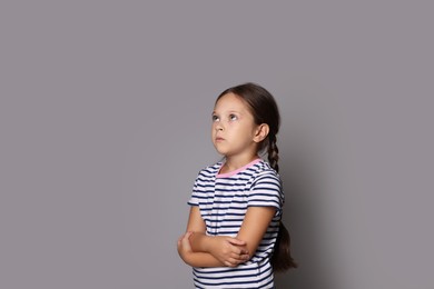 Photo of Orphanage concept. Sad girl on gray background